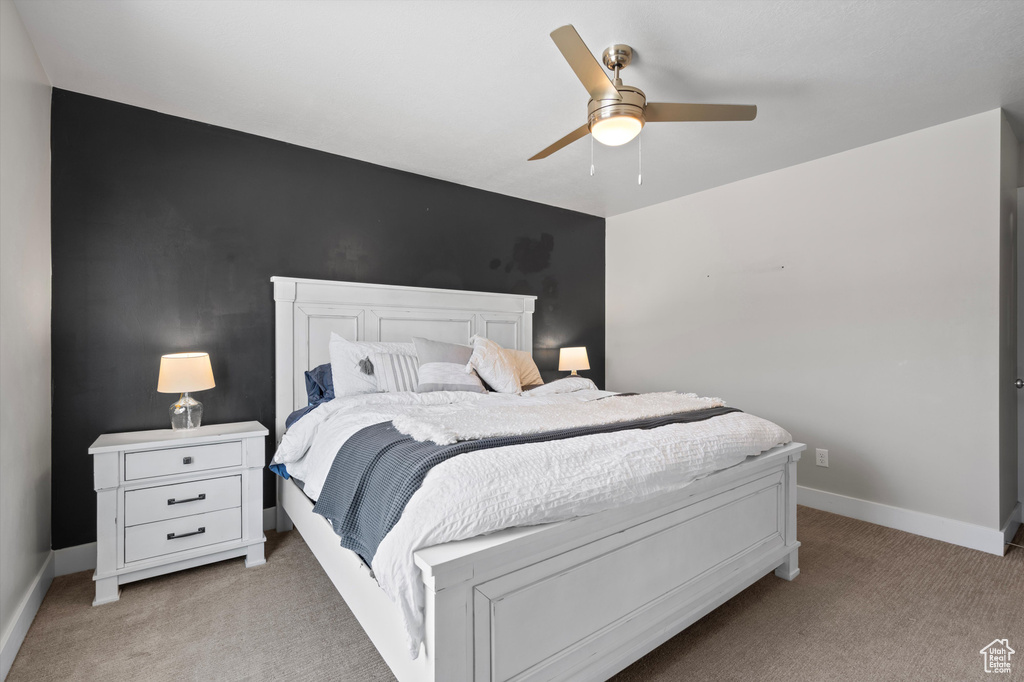 Bedroom with light carpet and ceiling fan