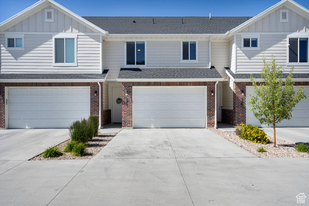 Townhome / multi-family property featuring a garage