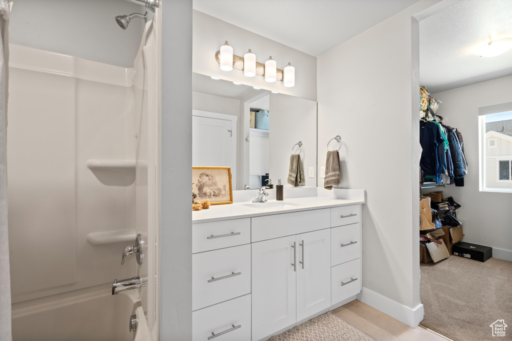 Bathroom featuring shower / bath combination and vanity