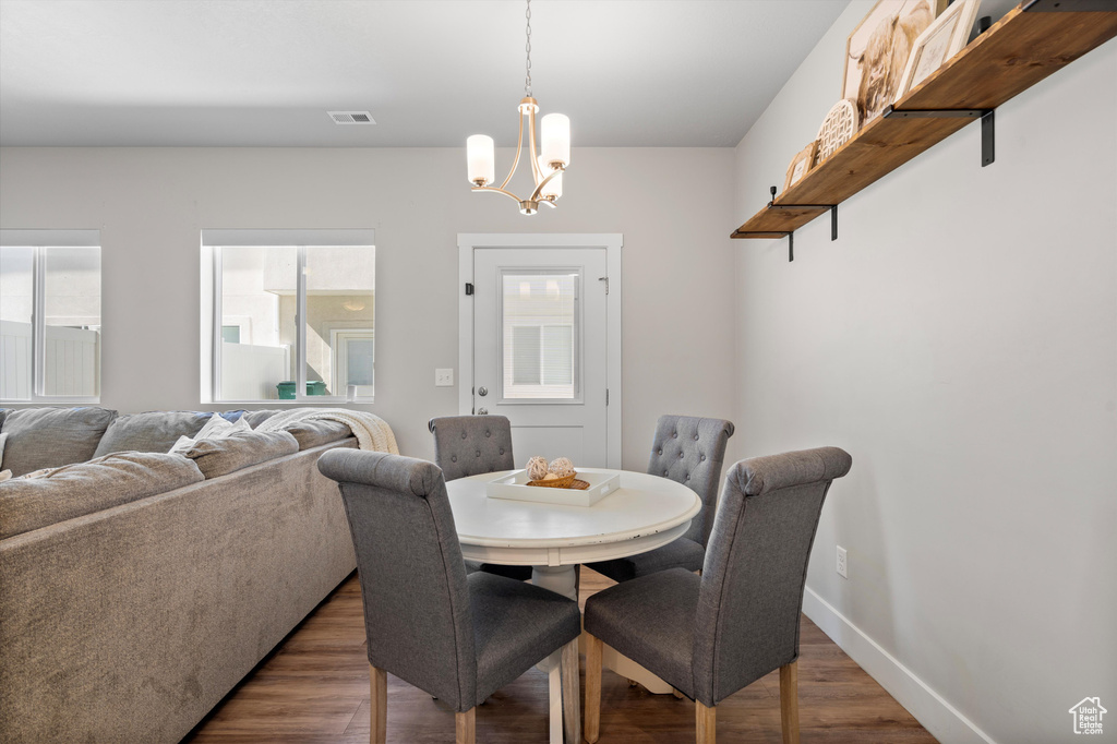 Dining room featuring a notable chandelier and dark hardwood / wood-style flooring