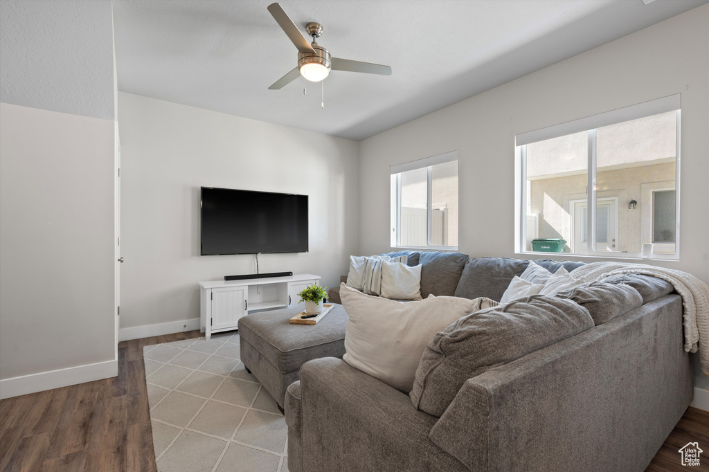 Living room with ceiling fan and hardwood / wood-style flooring