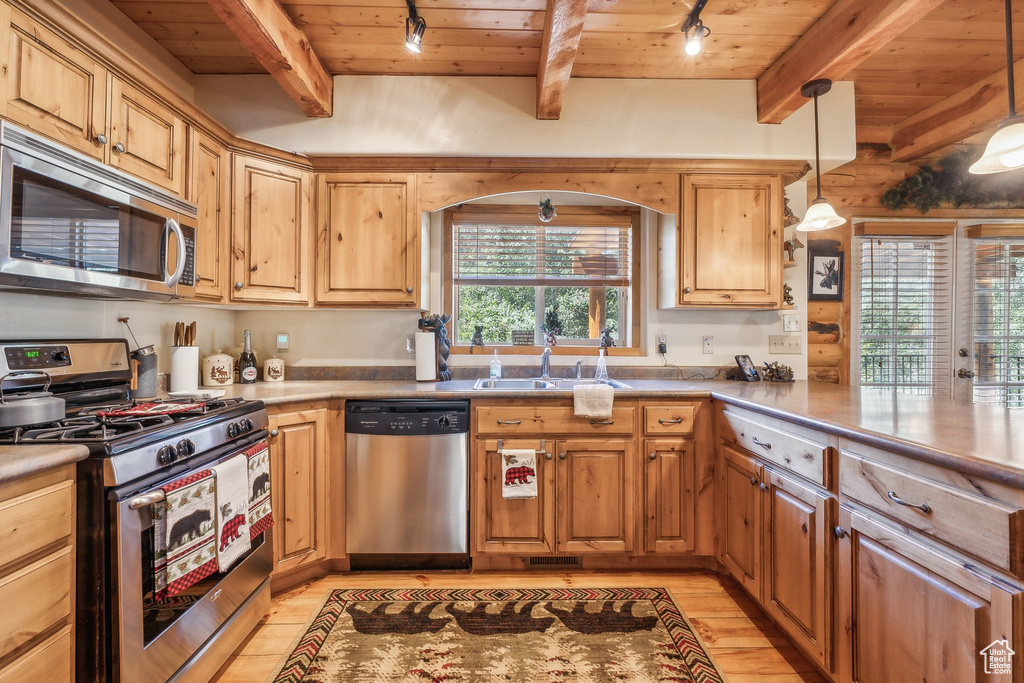 Kitchen with appliances with stainless steel finishes, beam ceiling, wood ceiling, and light wood-type flooring