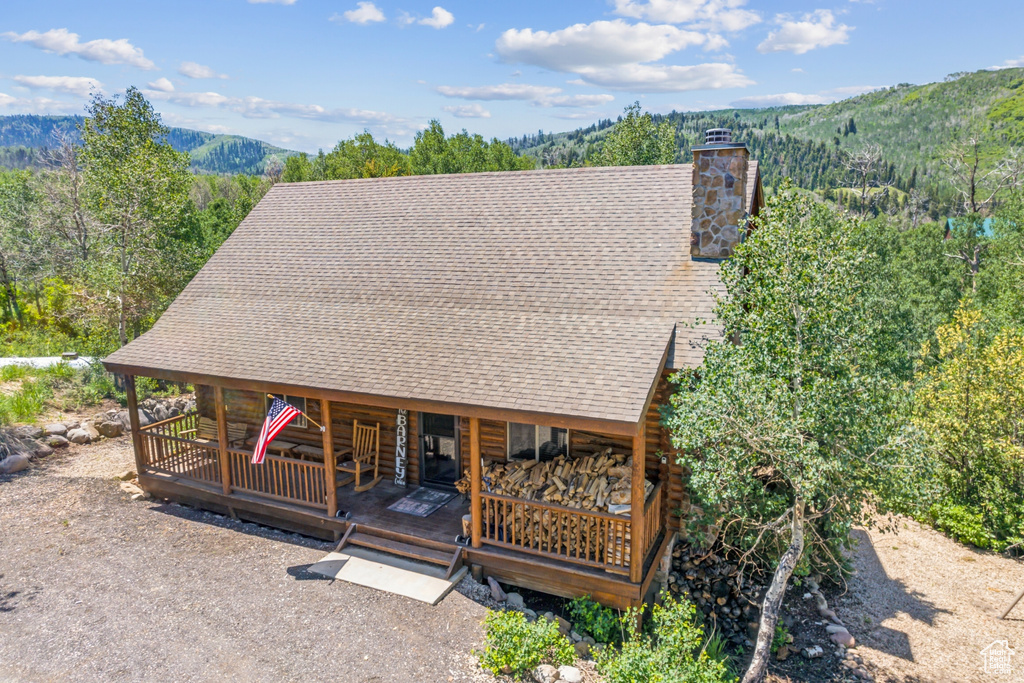 Log-style house with a deck with mountain view