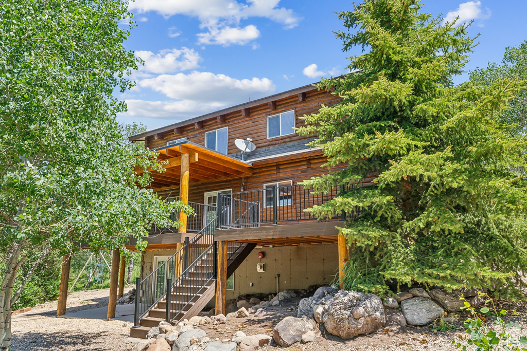 Back of property with a wooden deck