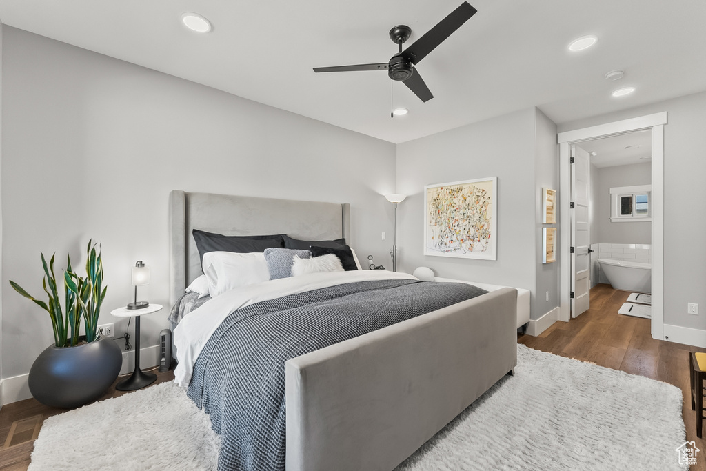 Bedroom with ceiling fan, dark hardwood / wood-style flooring, and ensuite bathroom