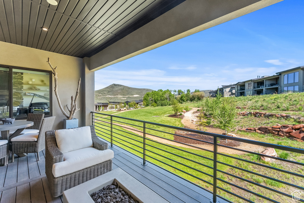 Balcony featuring an outdoor fire pit and a mountain view