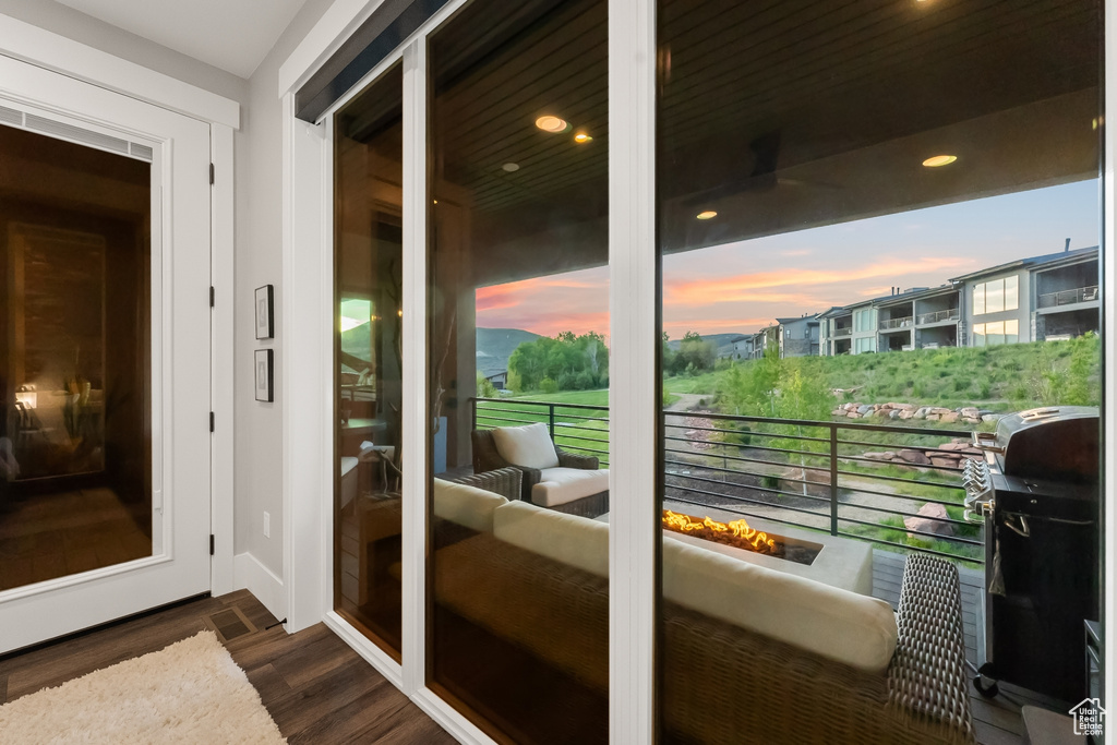 Balcony at dusk featuring outdoor lounge area and grilling area