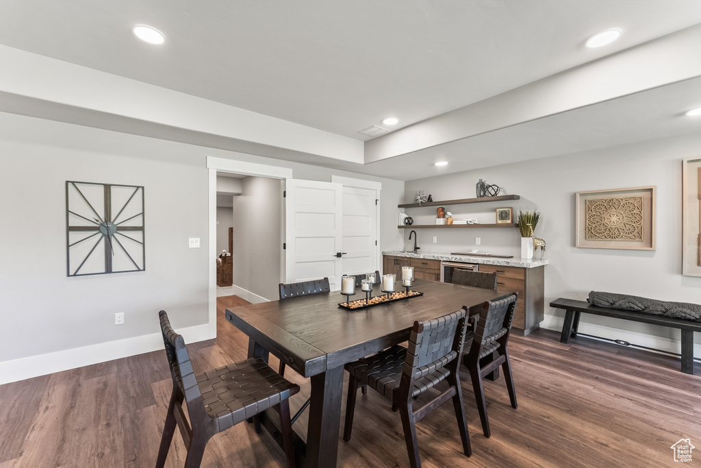 Dining area featuring sink and dark hardwood / wood-style floors