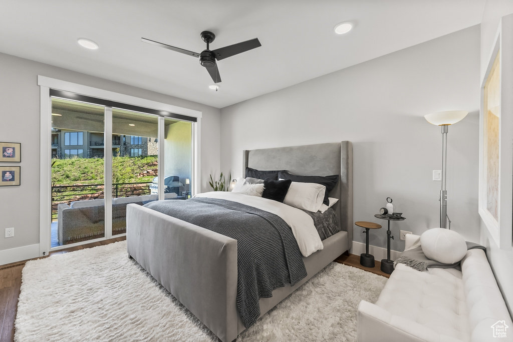 Bedroom featuring access to outside, hardwood / wood-style flooring, and ceiling fan