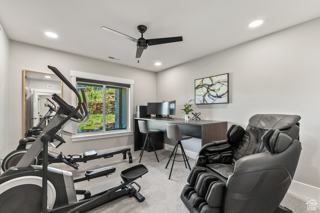 Exercise area featuring ceiling fan and light colored carpet