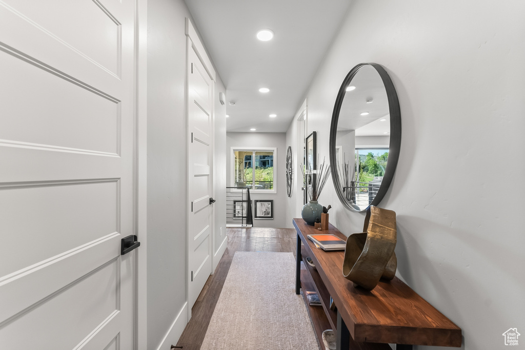 Hallway with dark hardwood / wood-style flooring