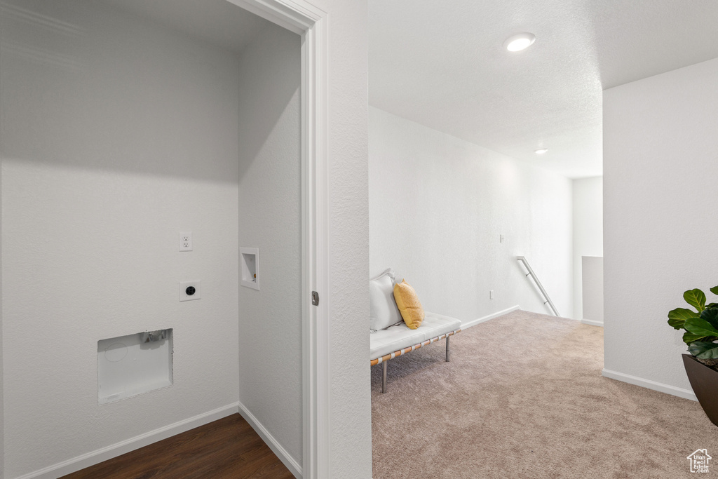 Washroom with washer hookup, dark hardwood / wood-style flooring, and hookup for an electric dryer