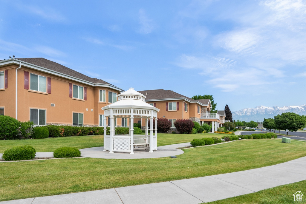 Exterior space with a gazebo, a mountain view, and a yard