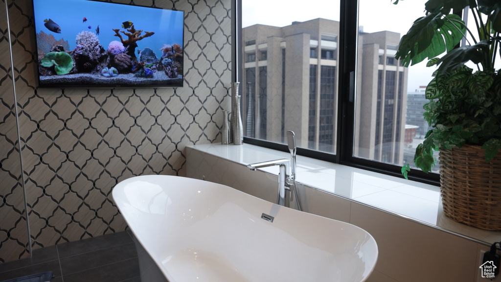 Bathroom with a tub and tile floors