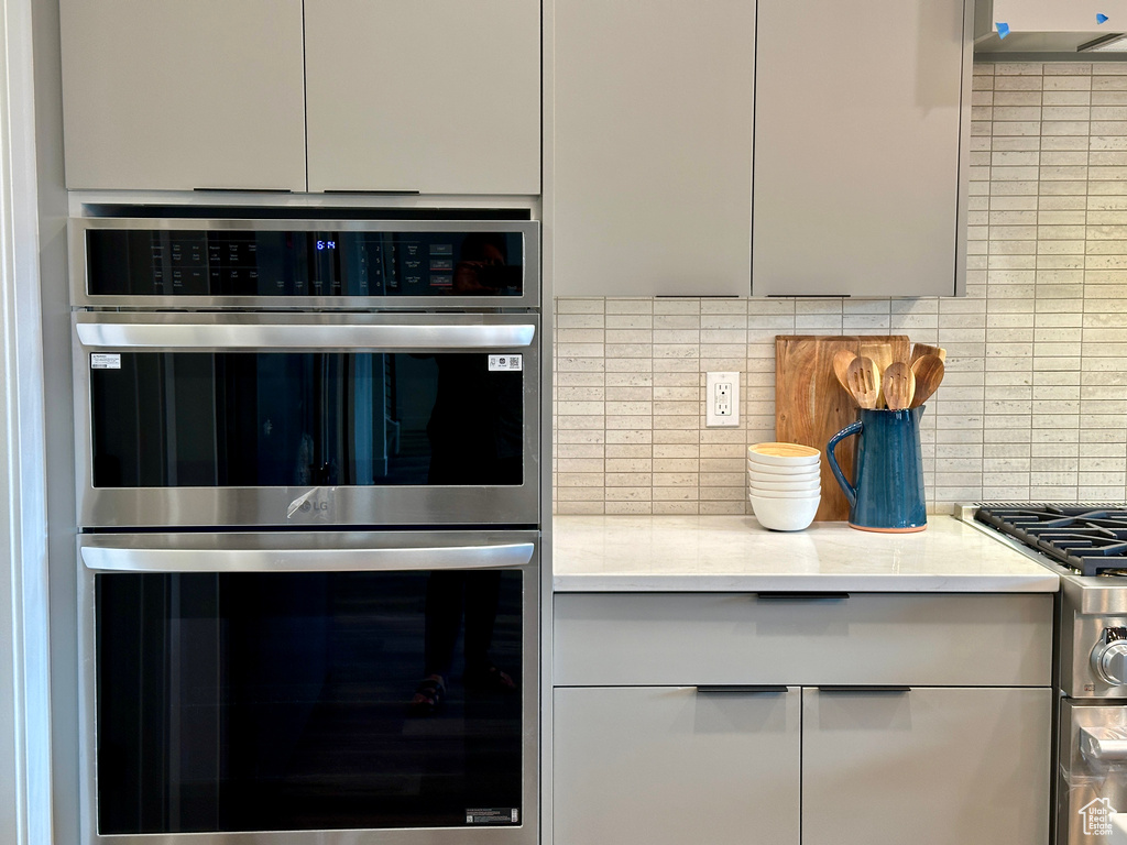 Kitchen featuring tasteful backsplash and appliances with stainless steel finishes