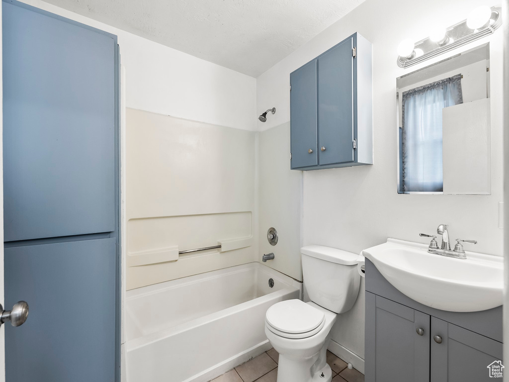 Full bathroom with toilet, vanity, shower / bathing tub combination, and tile floors