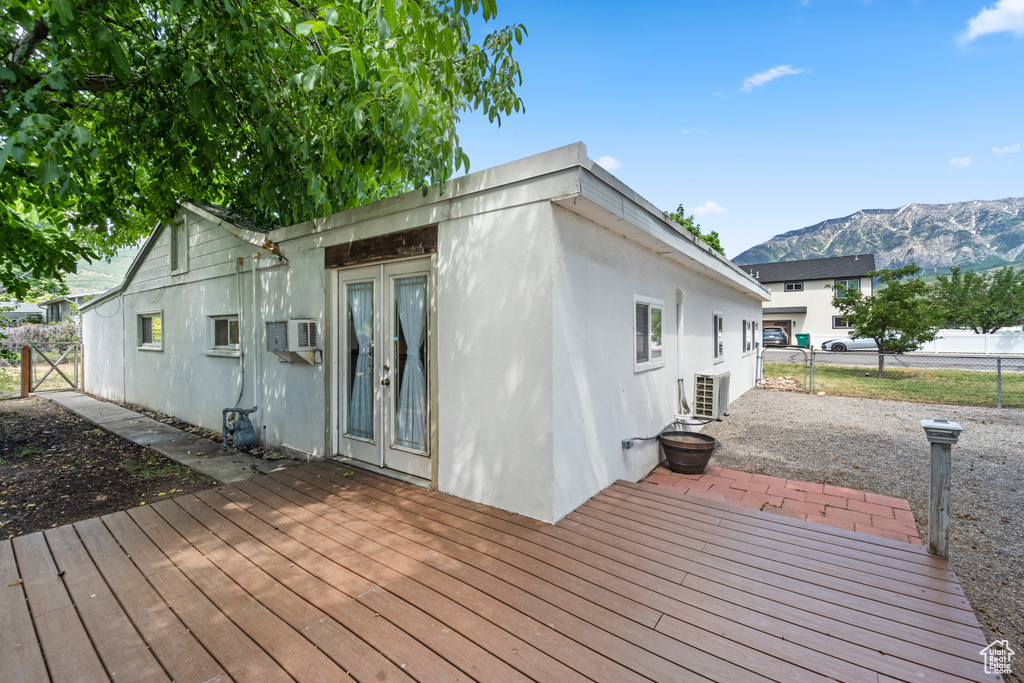 Wooden terrace featuring a mountain view and french doors