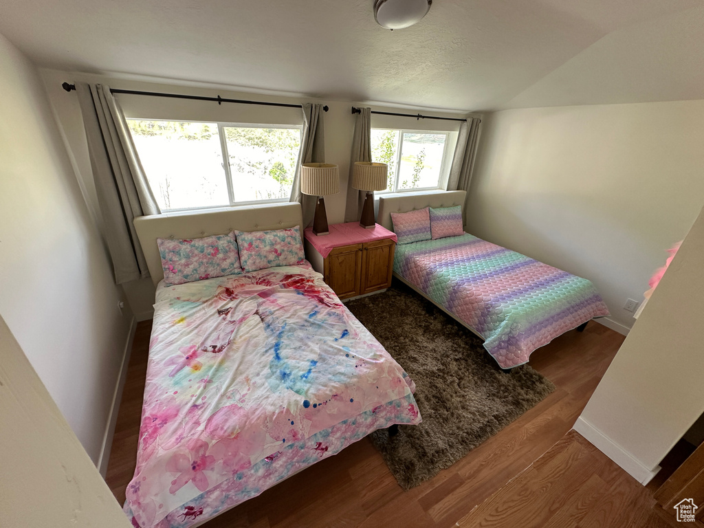 Bedroom with hardwood / wood-style flooring