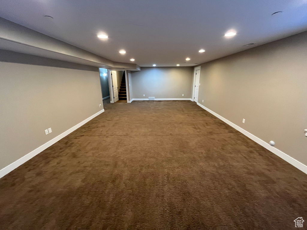 Basement featuring dark carpet