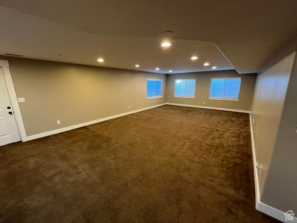 Basement with dark carpet