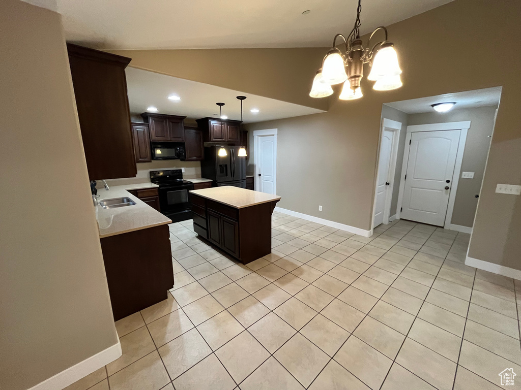 Kitchen featuring a center island, black appliances, dark brown cabinets, and pendant lighting