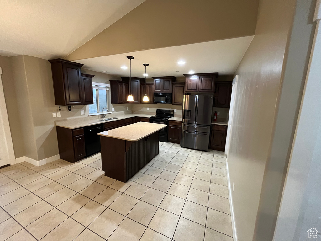 Kitchen featuring dark brown cabinets, vaulted ceiling, pendant lighting, black appliances, and a center island