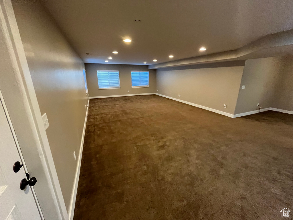 Unfurnished room with dark carpet