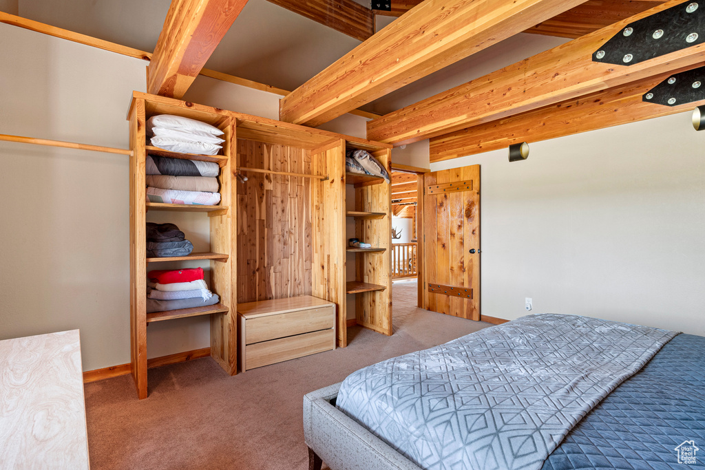 Bedroom featuring beam ceiling and carpet flooring