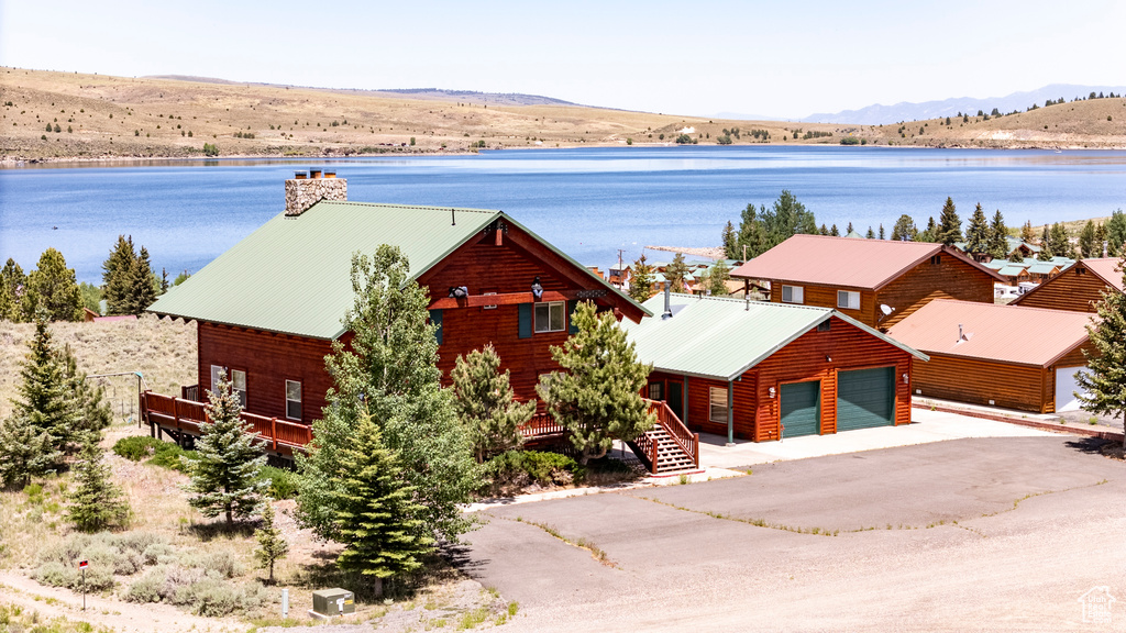 View of front of property featuring a garage and a water and mountain view