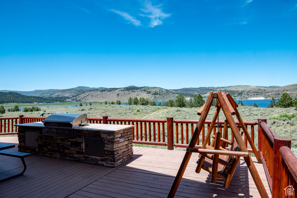 Deck featuring a mountain view and area for grilling