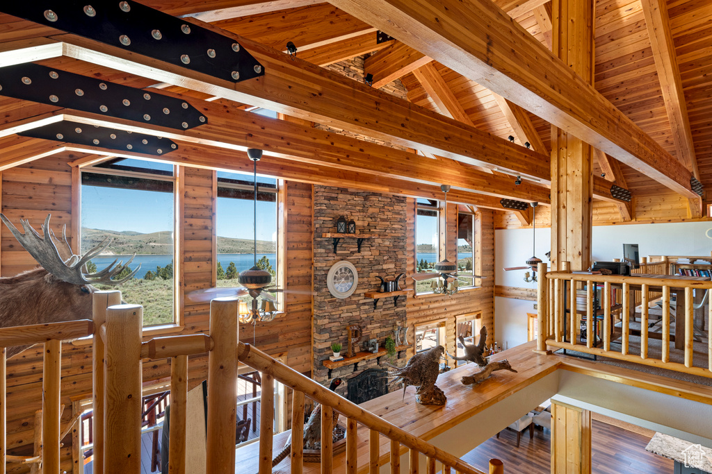 Corridor featuring beam ceiling, wooden ceiling, a water view, and hardwood / wood-style floors