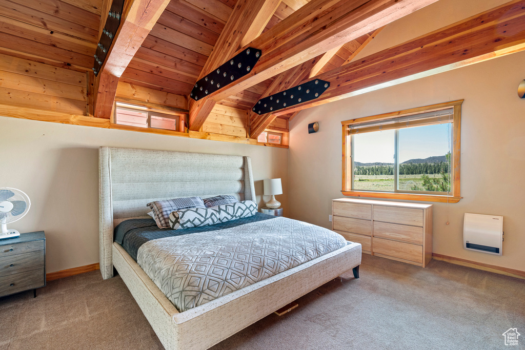 Bedroom featuring carpet floors, vaulted ceiling with beams, and wooden ceiling