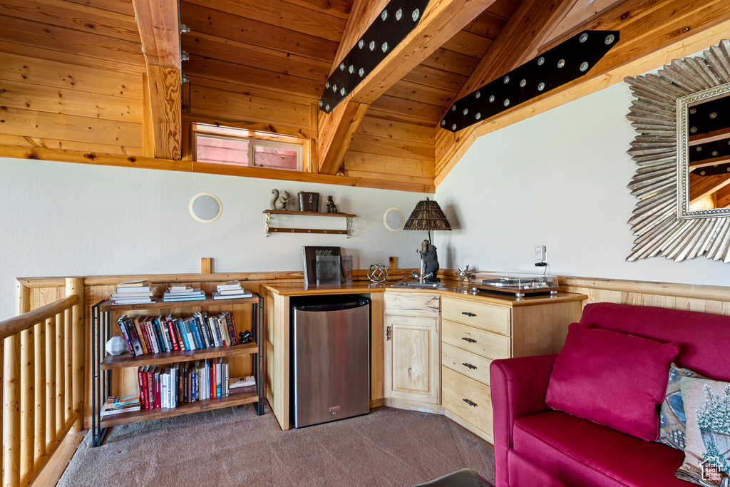 Sitting room featuring wooden ceiling, vaulted ceiling with beams, and carpet floors