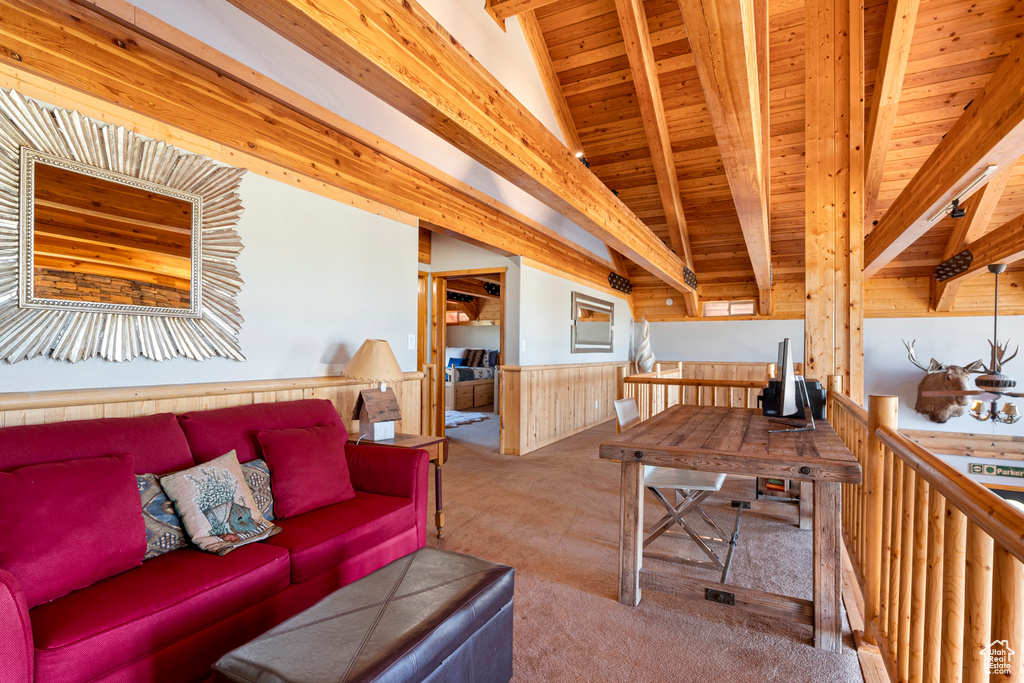 Living room featuring beam ceiling, carpet floors, and wooden ceiling