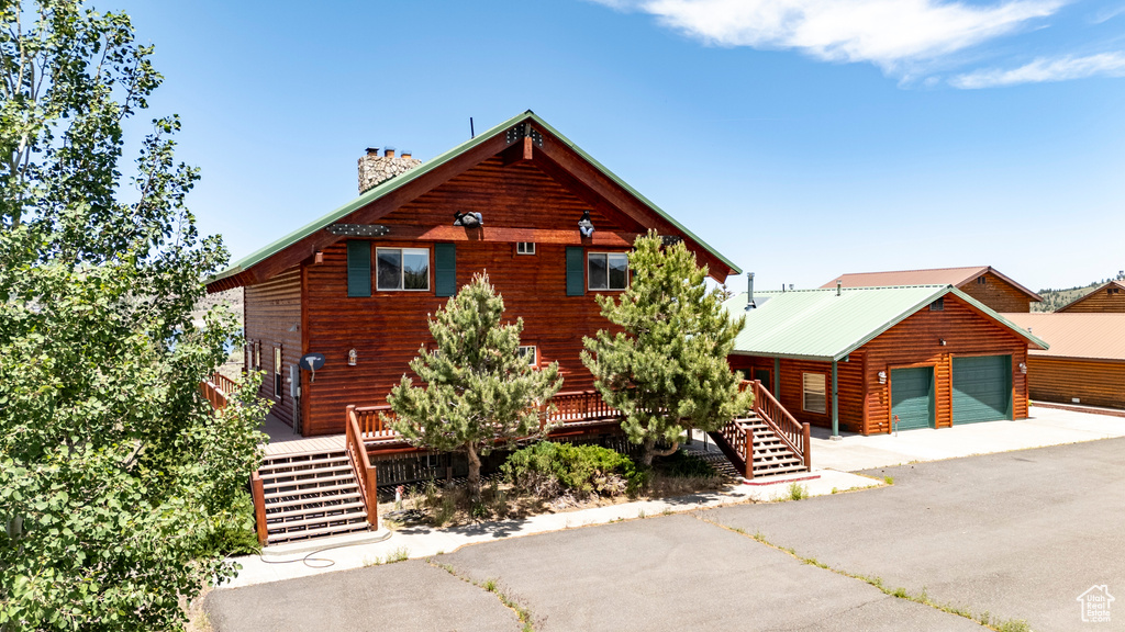 Log-style house featuring a garage