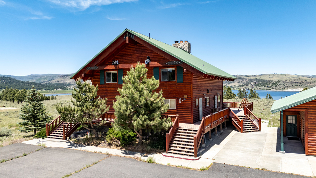 View of side of property featuring a deck with water view