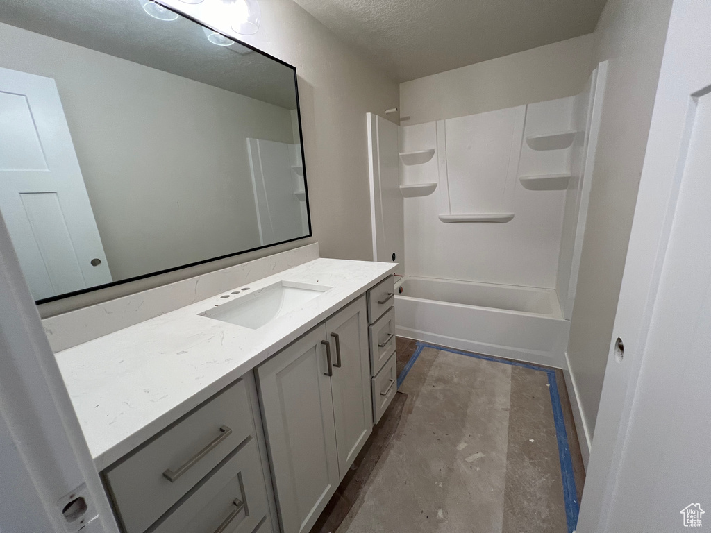 Bathroom with vanity, concrete flooring, and  shower combination