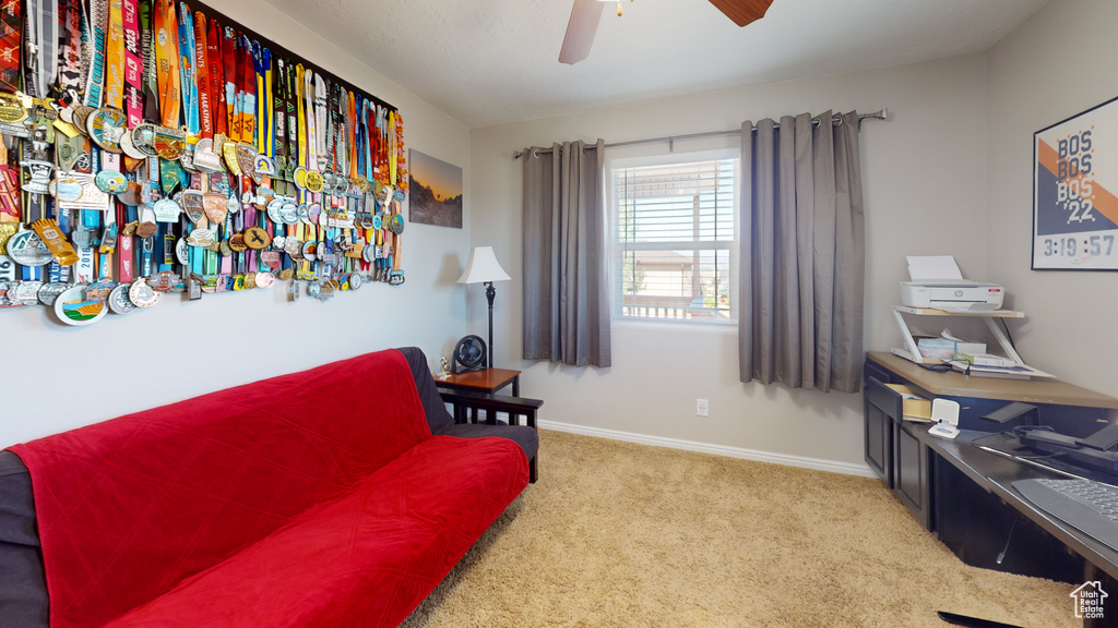 Sitting room featuring carpet flooring and ceiling fan