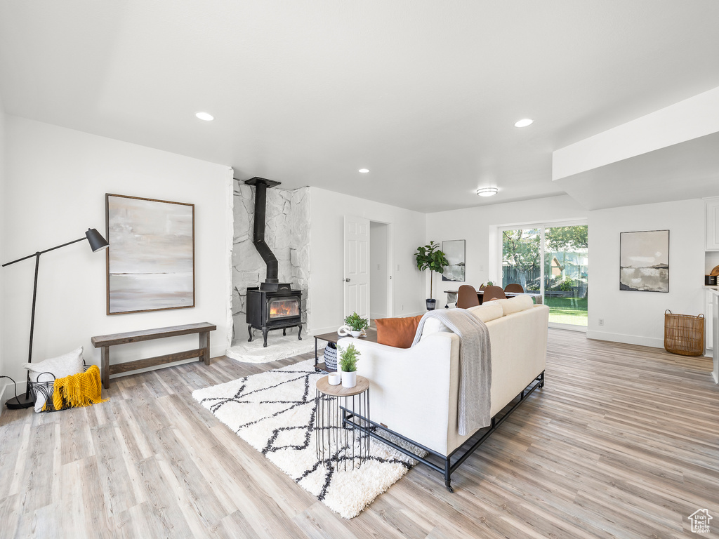 Living room featuring light wood-type flooring and a wood stove