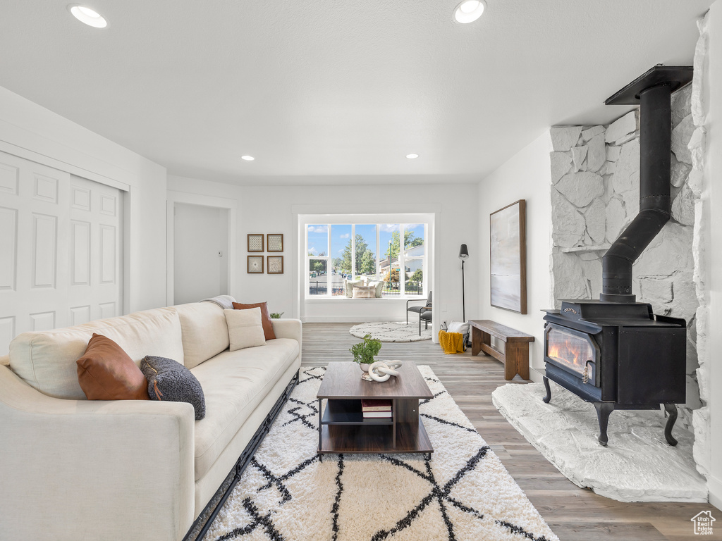 Living room with hardwood / wood-style floors and a wood stove