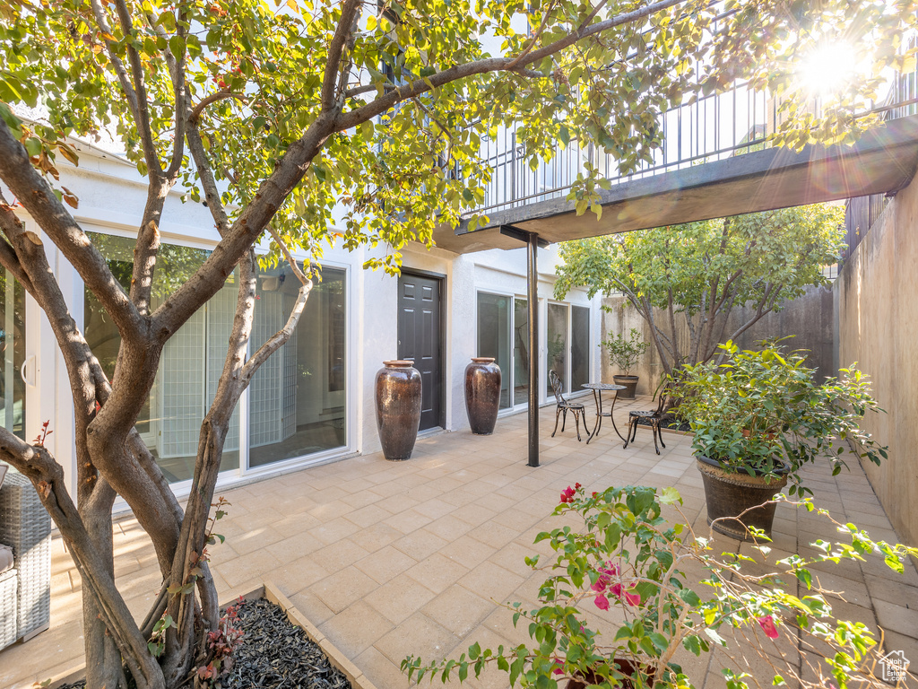 View of patio featuring a balcony