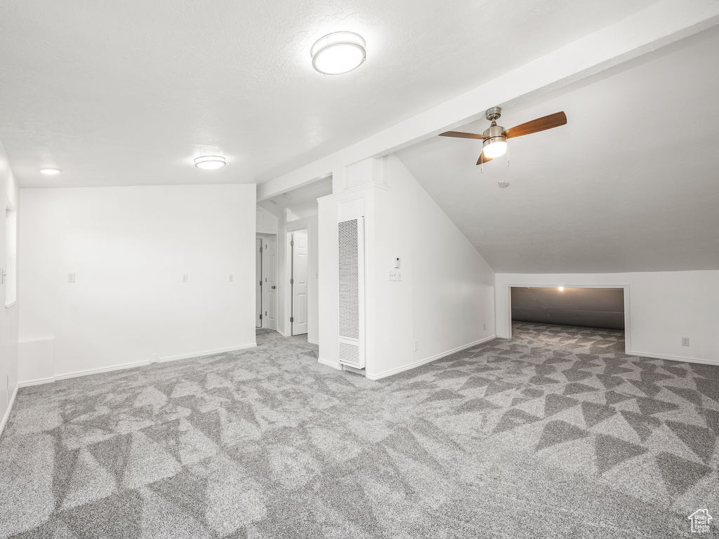 Bonus room featuring ceiling fan, carpet floors, and lofted ceiling