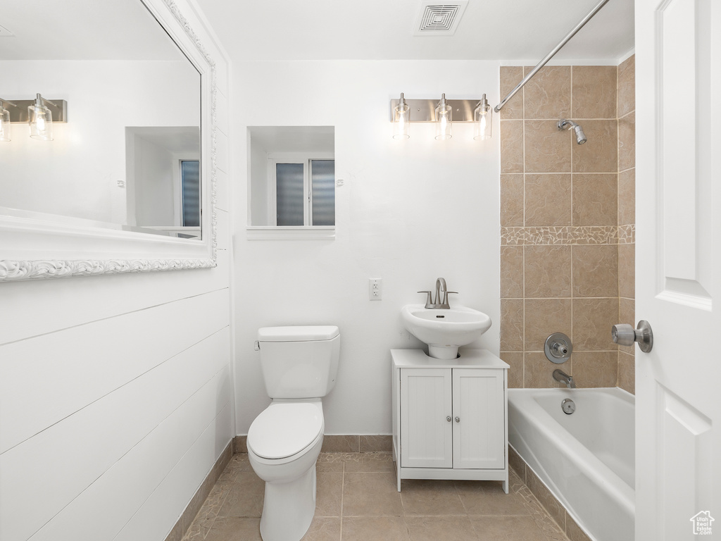 Full bathroom featuring tile flooring, a bidet, vanity with extensive cabinet space, tiled shower / bath, and toilet