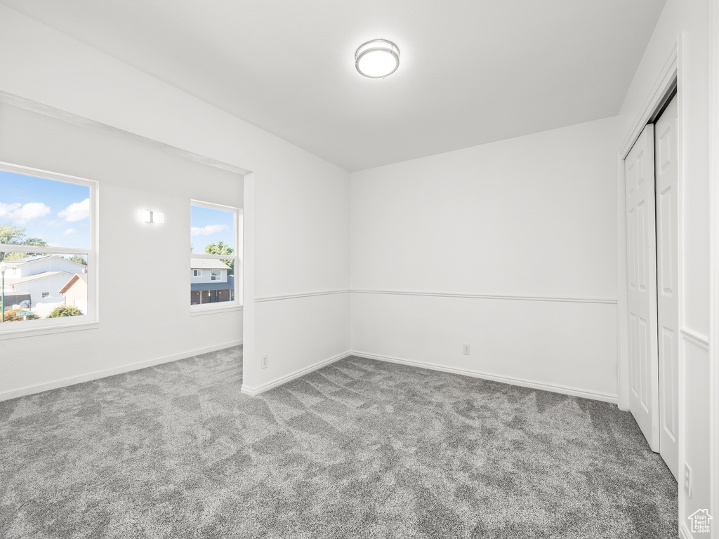 Unfurnished bedroom featuring a closet and carpet floors