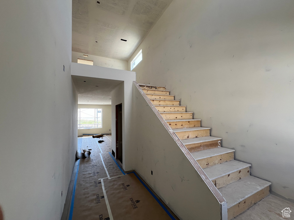 Stairs featuring a high ceiling