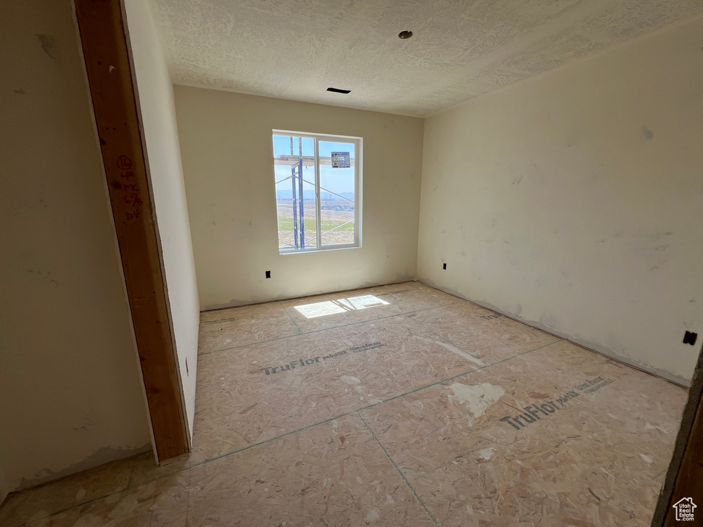 Spare room with a textured ceiling