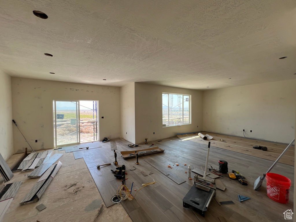 Spare room with a textured ceiling and a healthy amount of sunlight