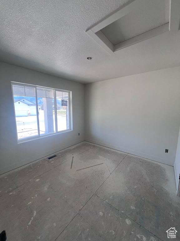 Spare room featuring a textured ceiling