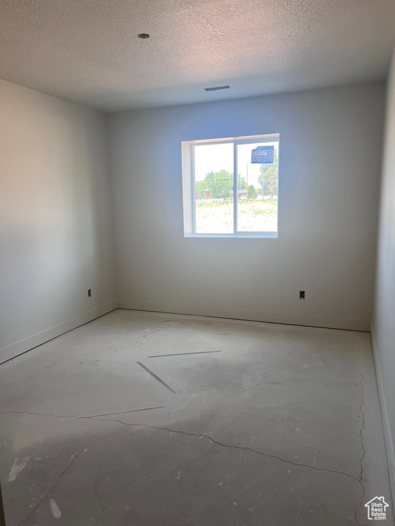 Empty room with a textured ceiling