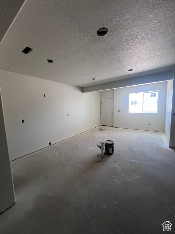 Basement featuring a textured ceiling